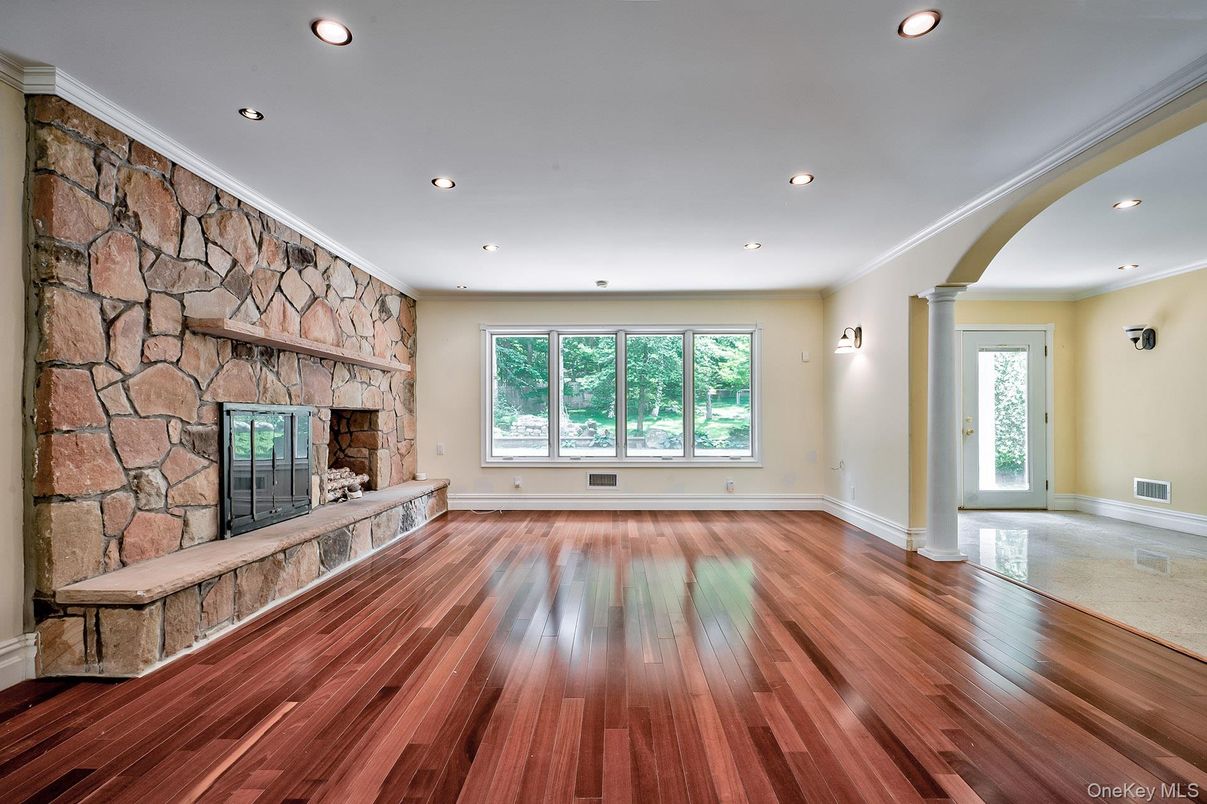 Empty room, Fireplace, Interior, Recessed Lighting, Stone Walls, Wood Texture Flooring