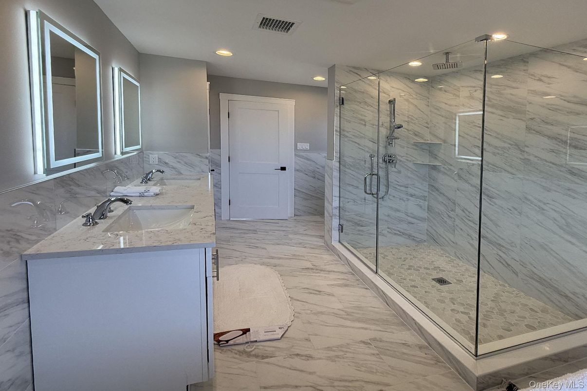 Bathroom, Dual Sink Vanities, Glass Shower, Interior, Marble, Marble Walls, Recessed Lighting
