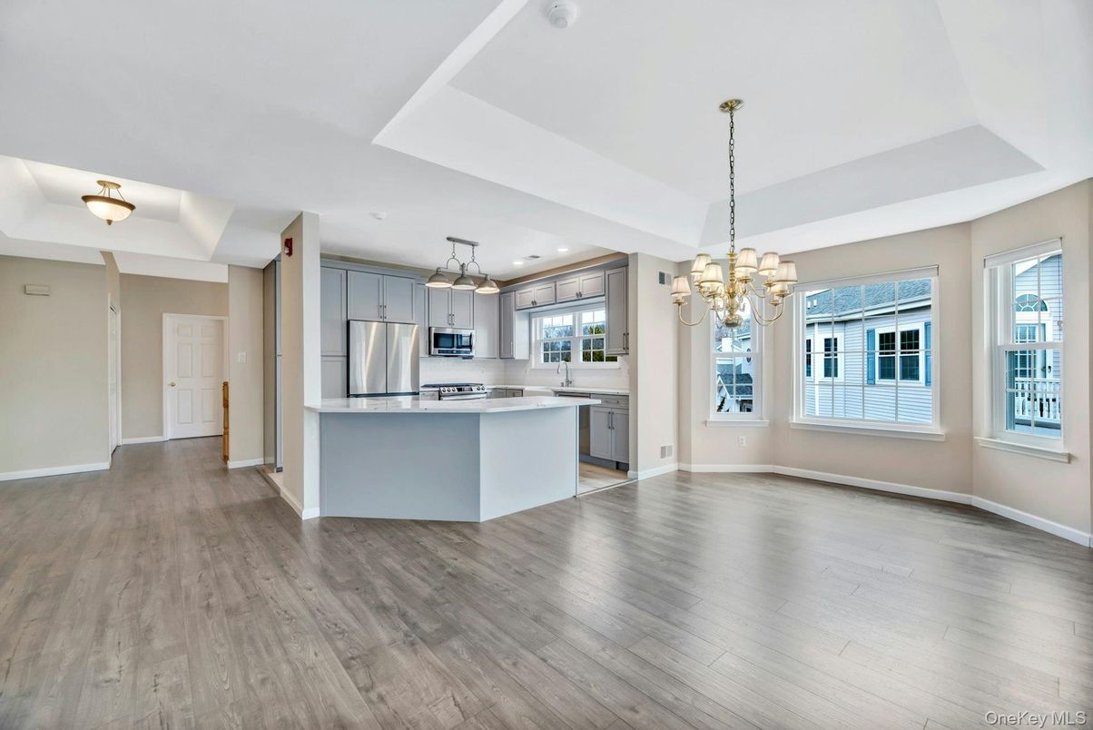 Chandelier, Empty room, Interior, Kitchen, Pendant Lights, Recessed Lighting, Stainless Steel Appliances, Wood Texture Flooring