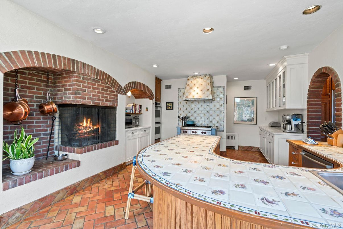 Fireplace, Interior, Kitchen, Recessed Lighting, Stainless Steel Appliances, Stone Walls, Tile Countertops