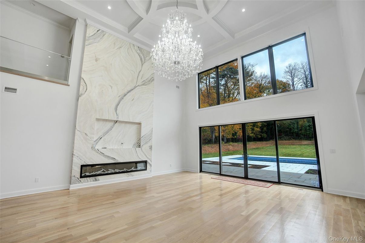 Chandelier, Fireplace, Interior, Marble Walls, Recessed Lighting, Wood Texture Flooring