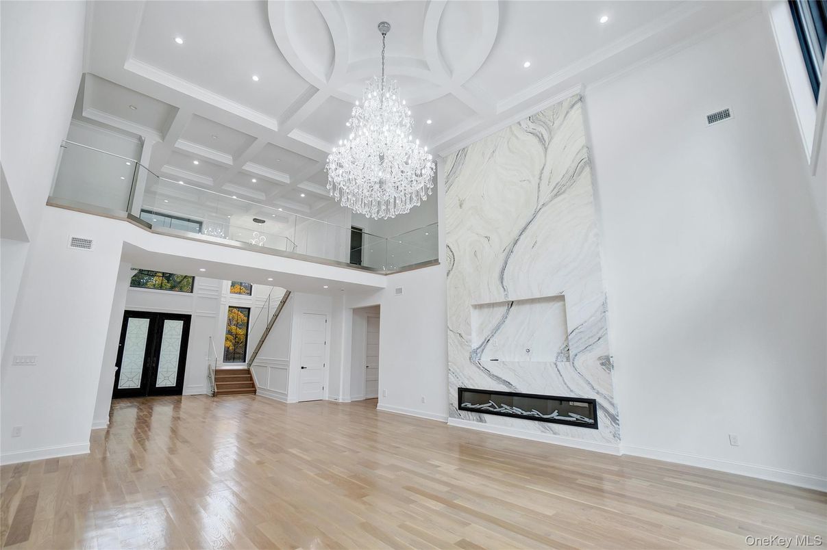 Chandelier, Fireplace, Interior, Marble Walls, Recessed Lighting, Wood Texture Flooring