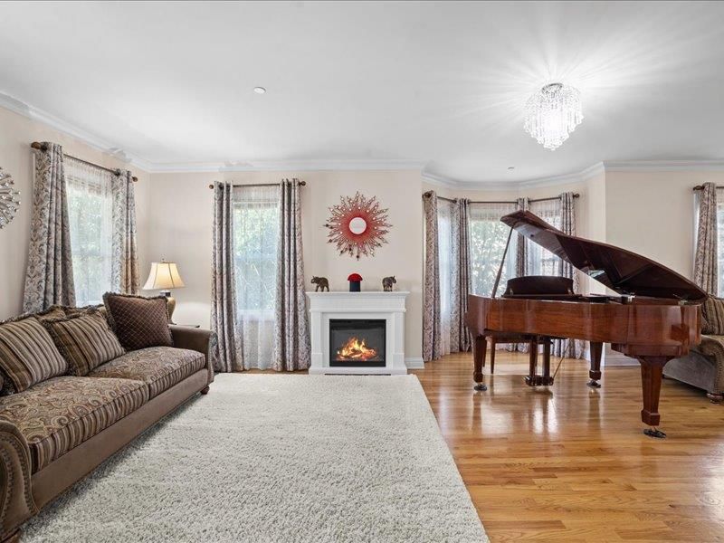 Chandelier, Fireplace, Interior, Living room, Piano, Recessed Lighting, Wood Texture Flooring