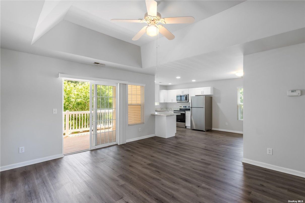 Empty room, Interior, Kitchen, Recessed Lighting, Stainless Steel Appliances, Wood Texture Flooring