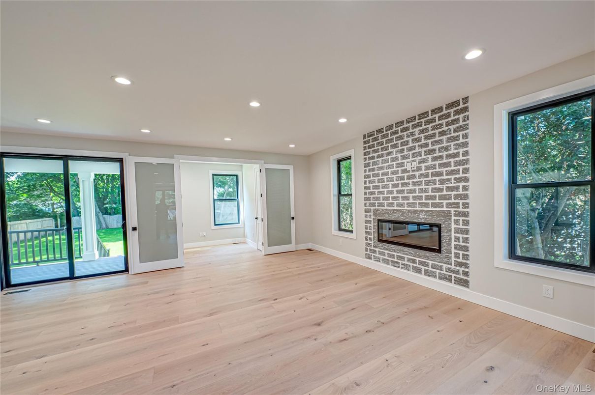 Empty room, Fireplace, Interior, Recessed Lighting, Stone Walls, Wood Texture Flooring