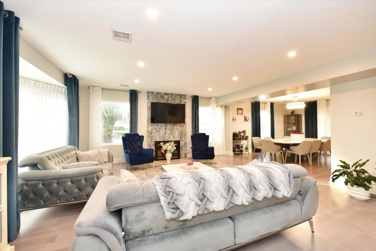 Chandelier, Dining room, Fireplace, Interior, Living room, Recessed Lighting, Stone Walls, Wood Texture Flooring