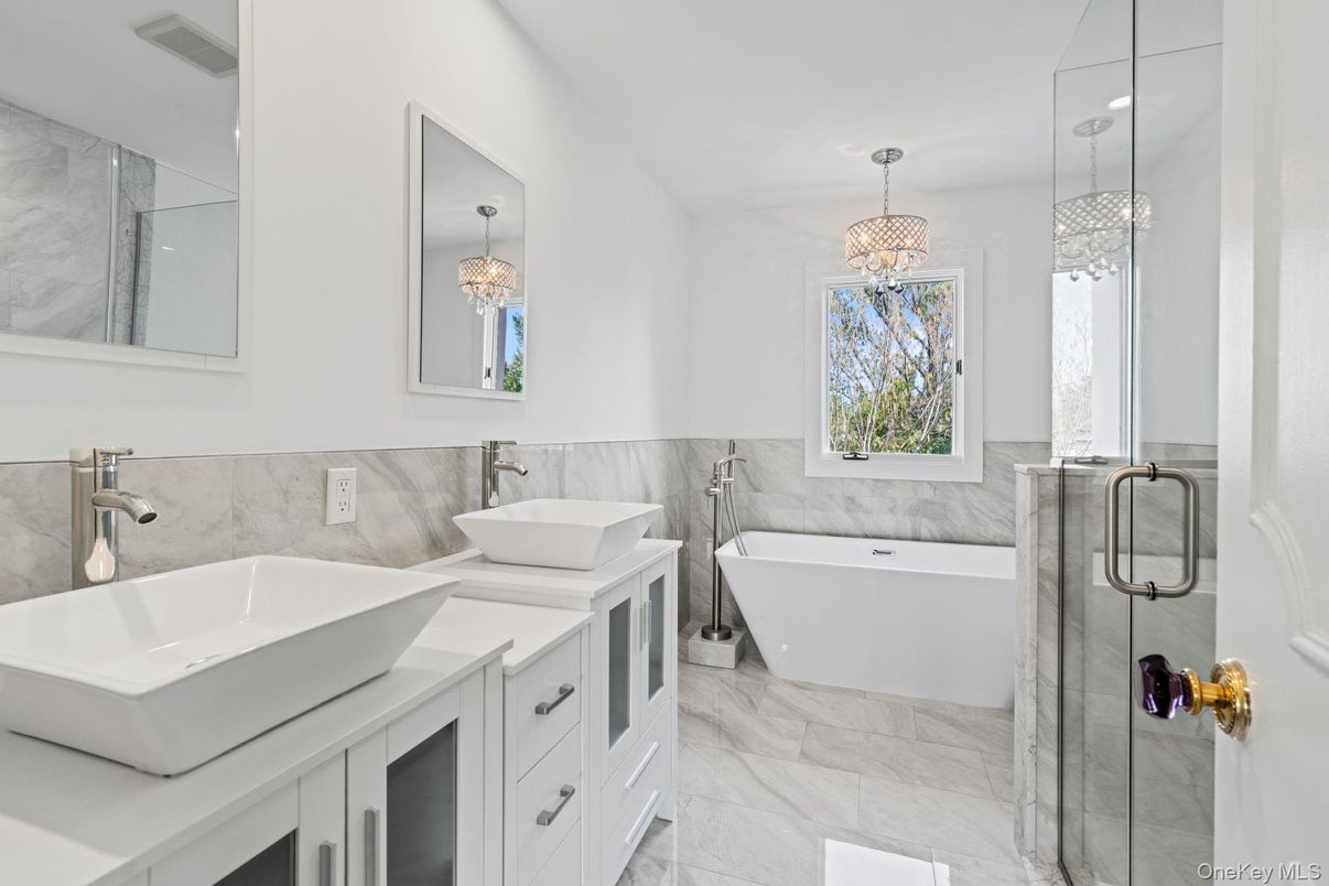 Bathroom, Chandelier, Dual Sink Vanities, Free Standing Baths, Glass Shower, Interior, Marble, Marble Walls, Pendant Lights