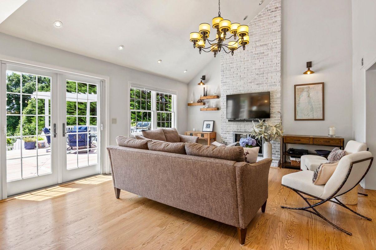 Chandelier, Fireplace, Interior, Living room, Recessed Lighting, Stone Walls, Wood Texture Flooring