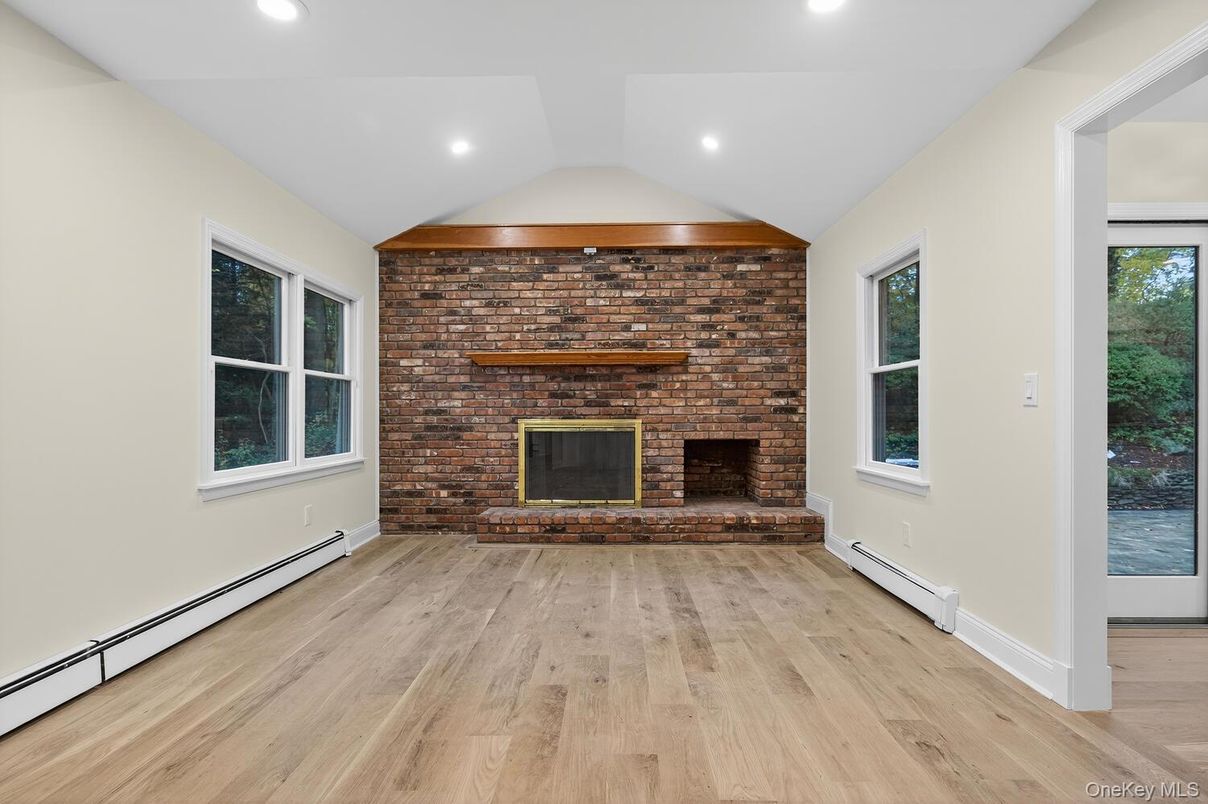 Empty room, Fireplace, Interior, Recessed Lighting, Stone Walls, Wood Texture Flooring