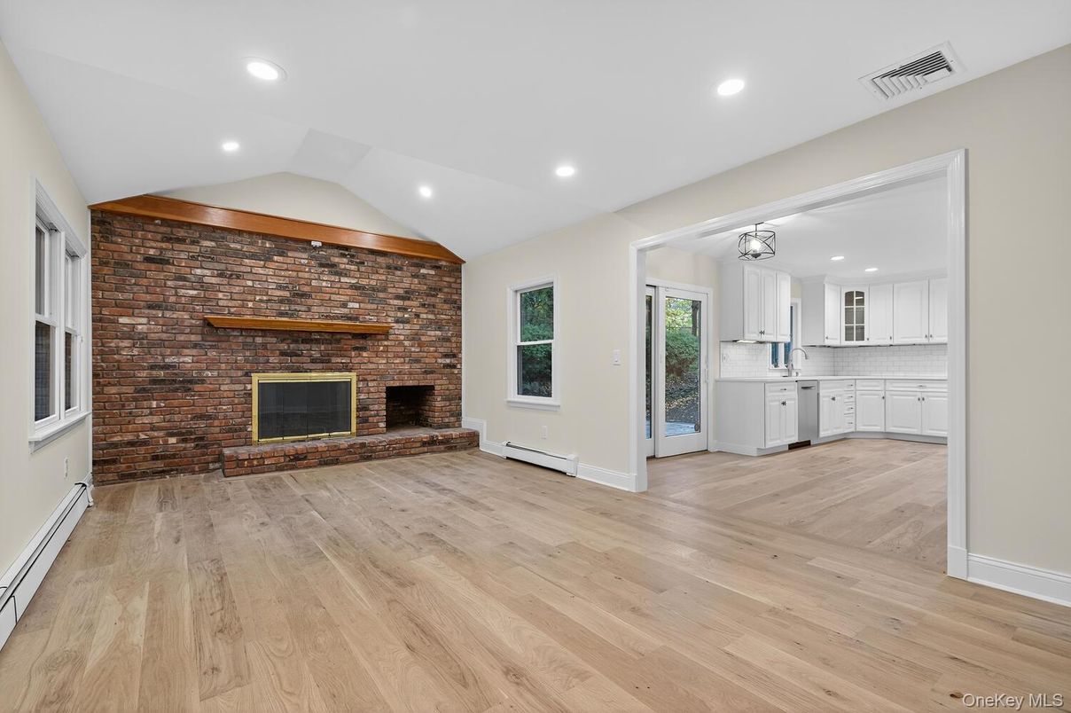 Empty room, Fireplace, Interior, Kitchen, Recessed Lighting, Stone Walls, Wood Texture Flooring