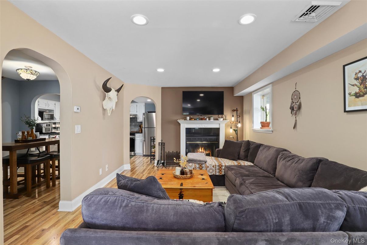 Dining room, Fireplace, Interior, Living room, Recessed Lighting, Wood Texture Flooring