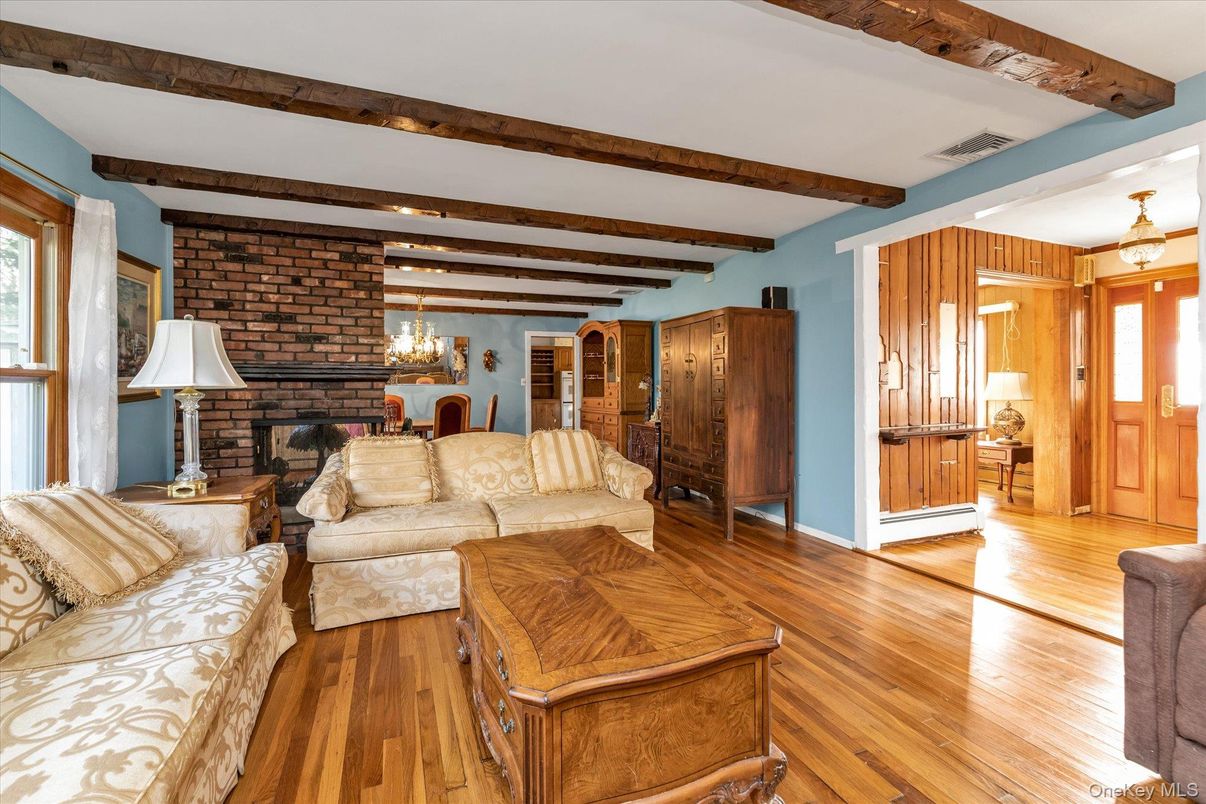 Chandelier, Fireplace, Interior, Living room, Recessed Lighting, Stone Walls, Wooden Beams, Wood Texture Flooring