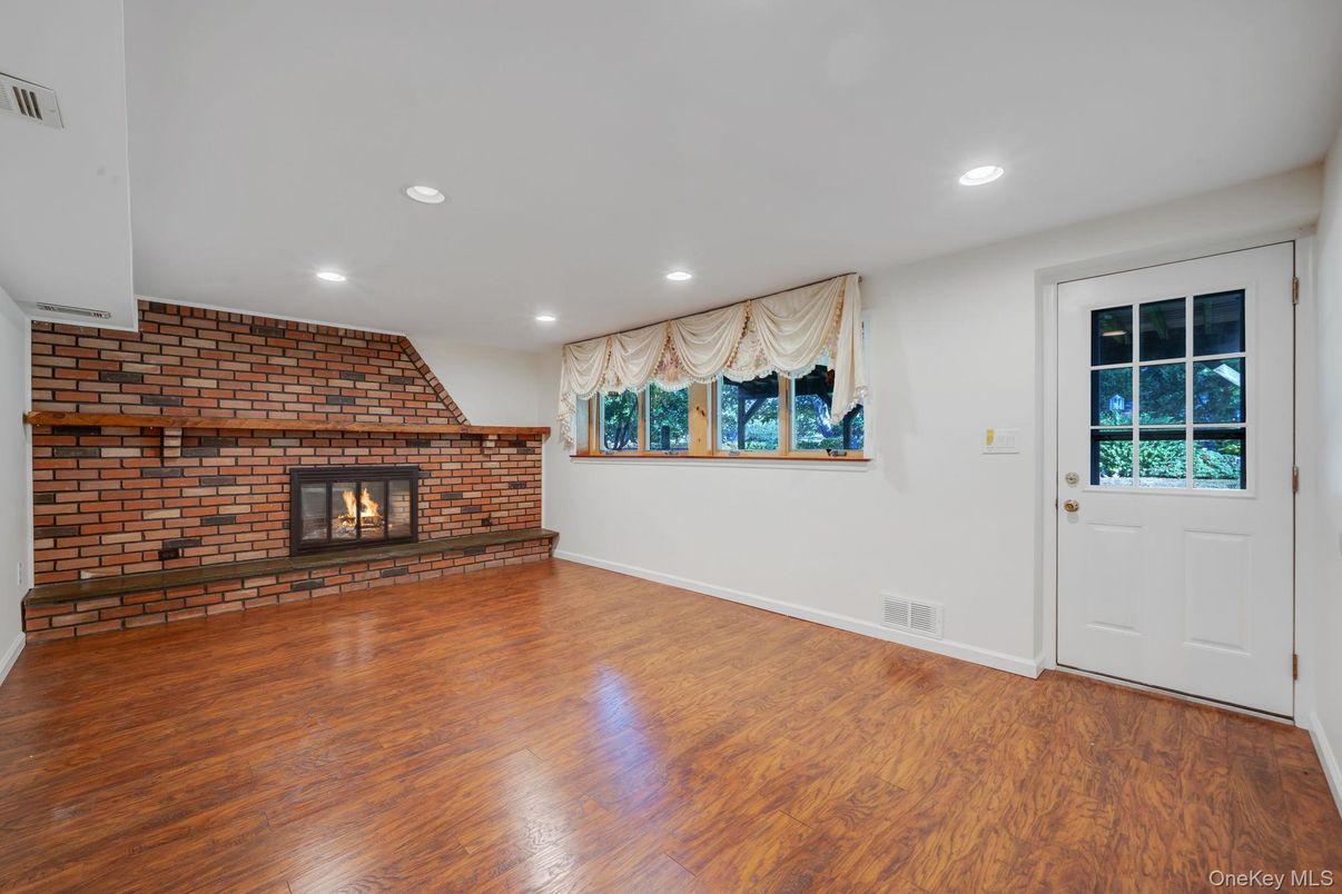 Empty room, Fireplace, Interior, Recessed Lighting, Stone Walls, Wood Texture Flooring