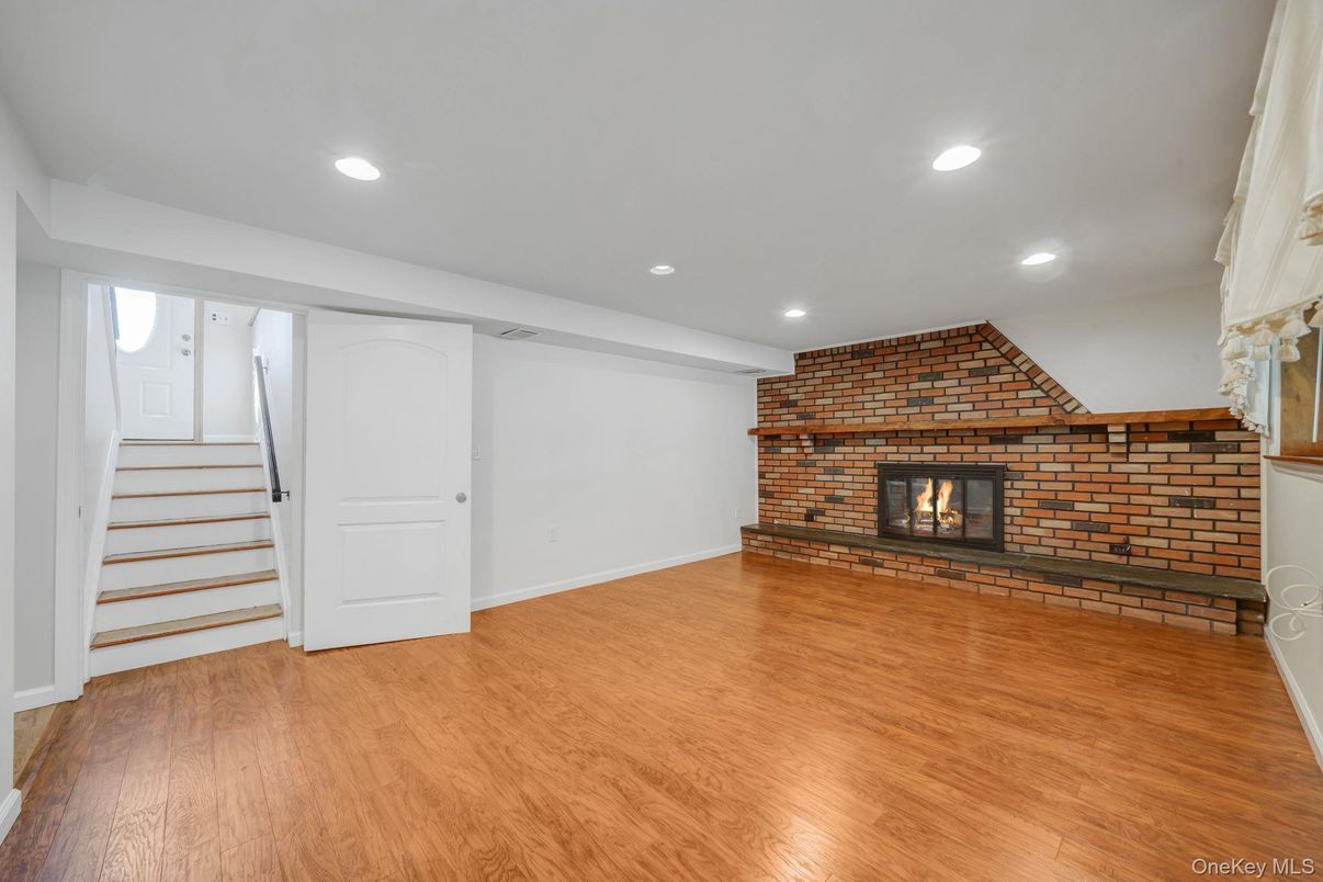 Empty room, Fireplace, Interior, Recessed Lighting, Stone Walls, Wood Texture Flooring