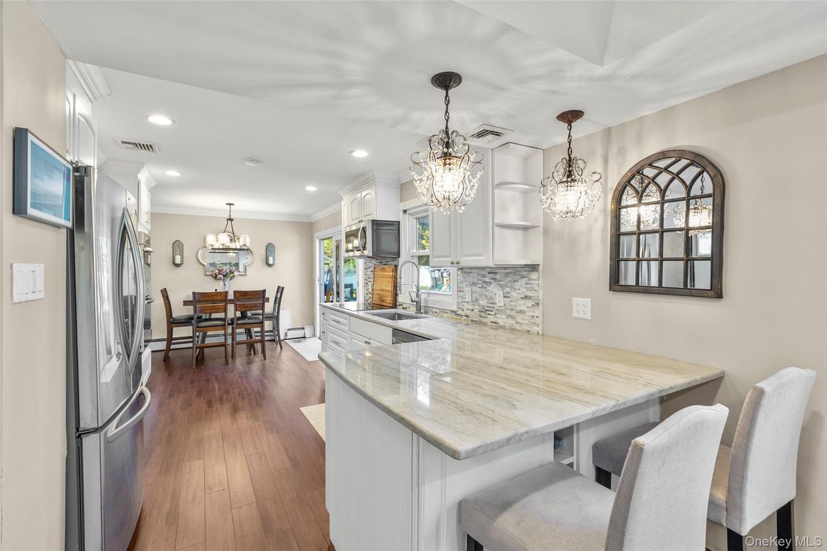 Chandelier, Dining room, Interior, Kitchen, Pendant Lights, Recessed Lighting, Stainless Steel Appliances, Wood Texture Flooring