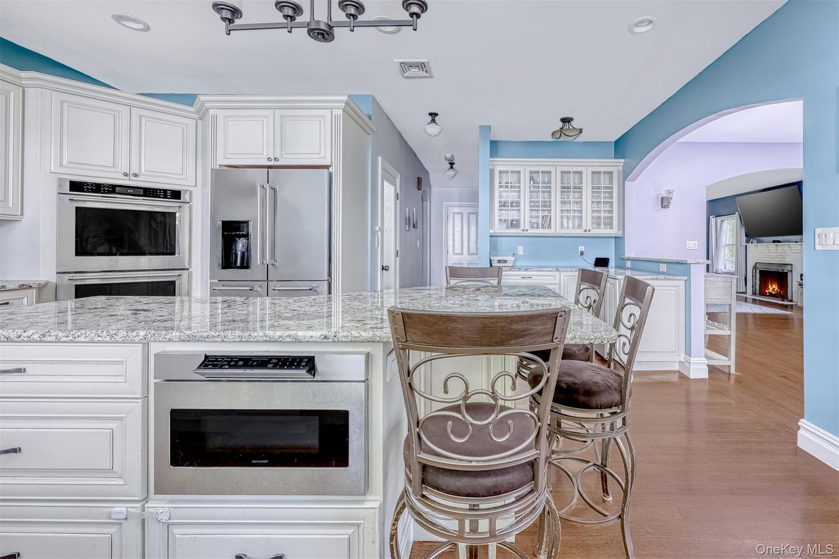 Fireplace, Interior, Kitchen, Recessed Lighting, Stainless Steel Appliances, Wood Texture Flooring