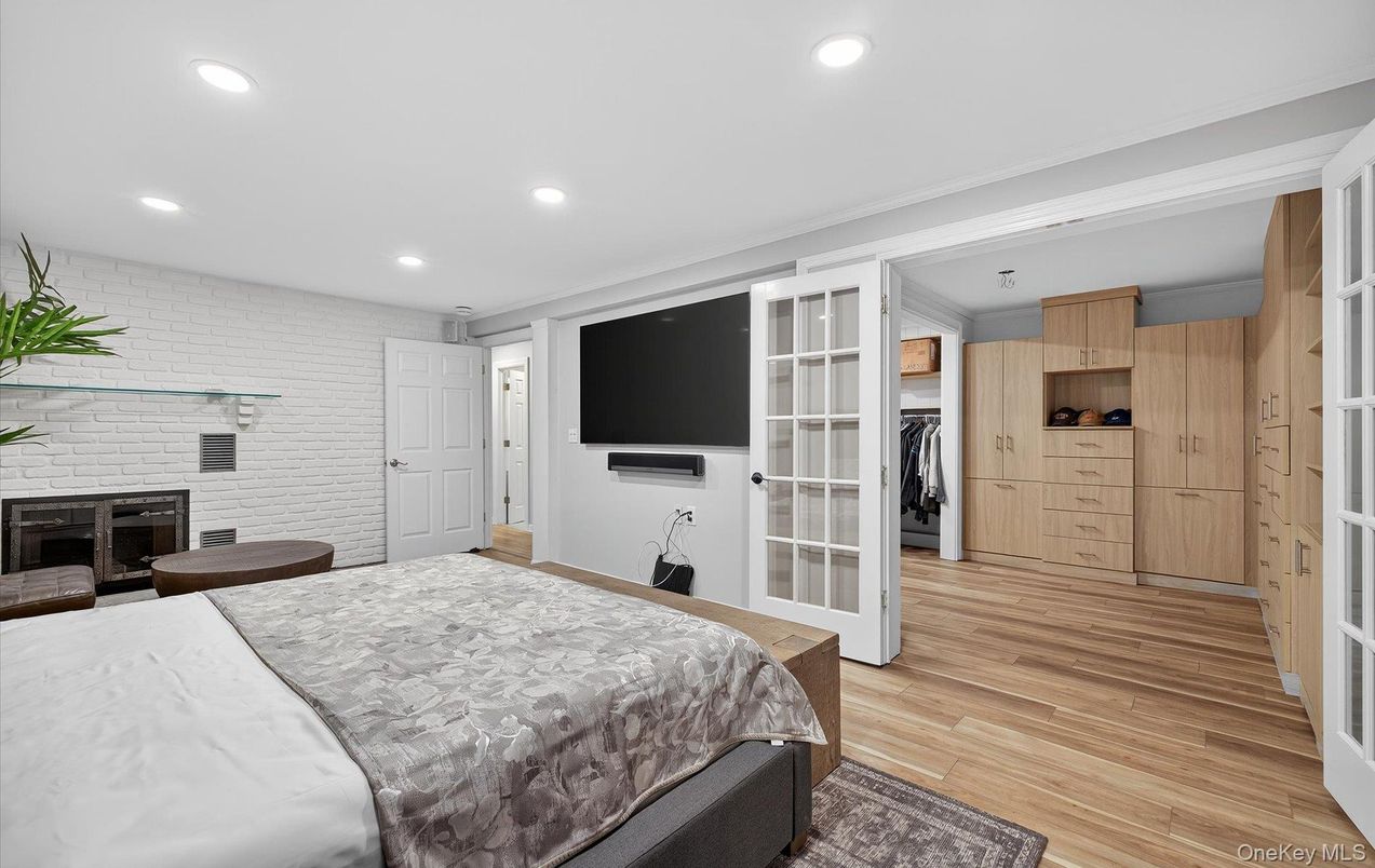 Bedroom, Fireplace, Interior, Recessed Lighting, Stone Walls, Wood Texture Flooring