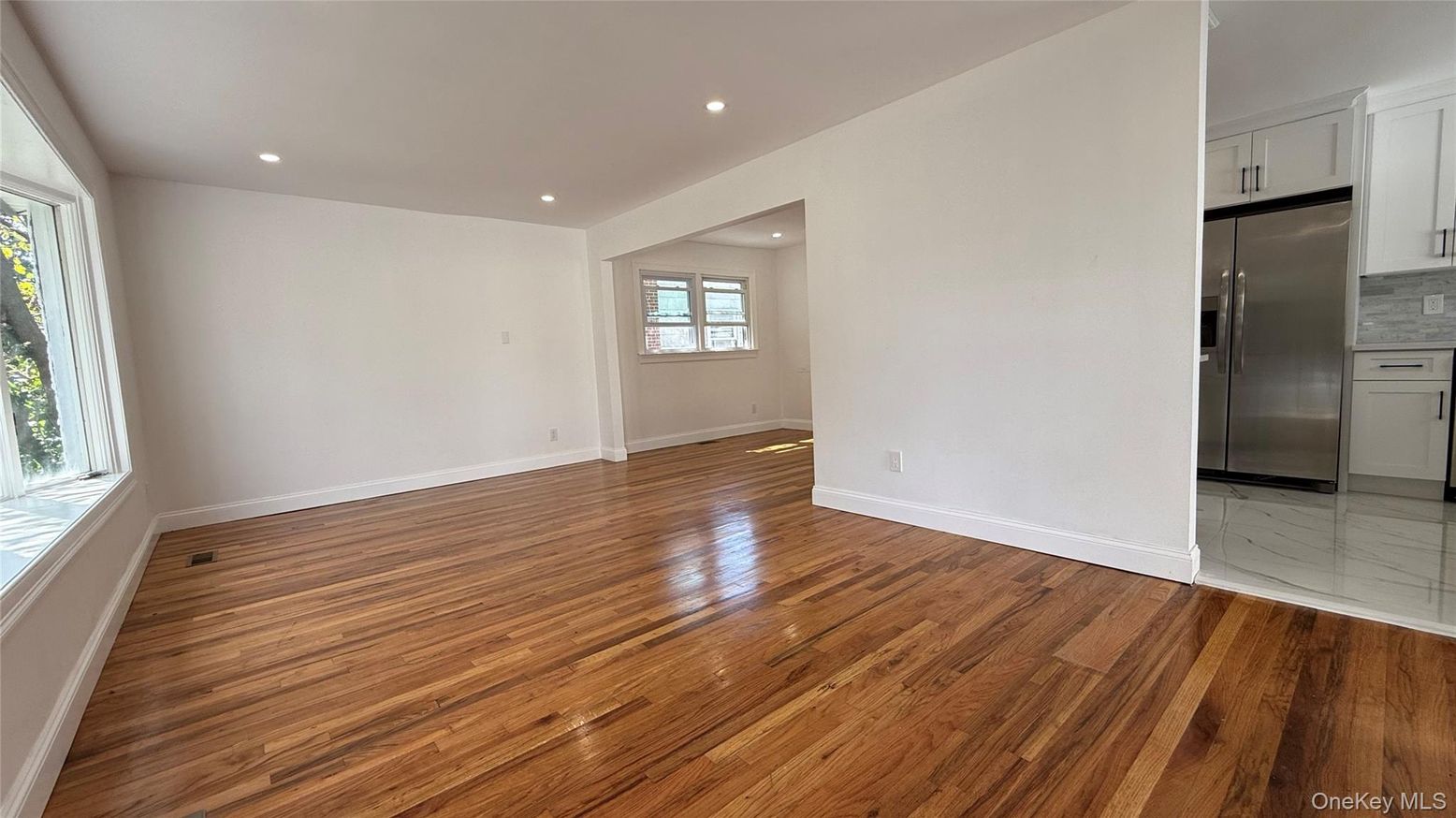 Empty room, Interior, Kitchen, Recessed Lighting, Stainless Steel Appliances, Wood Texture Flooring