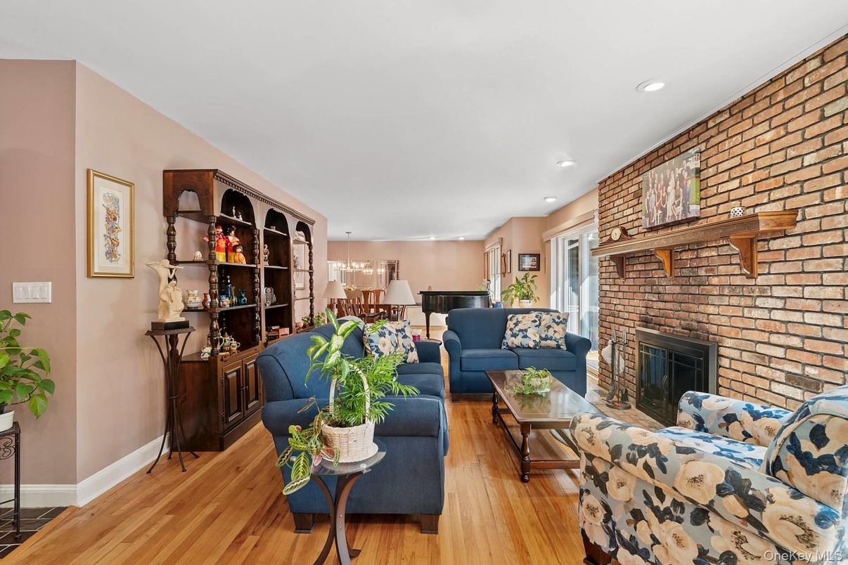 Chandelier, Fireplace, Interior, Living room, Piano, Recessed Lighting, Stone Walls, Wood Texture Flooring