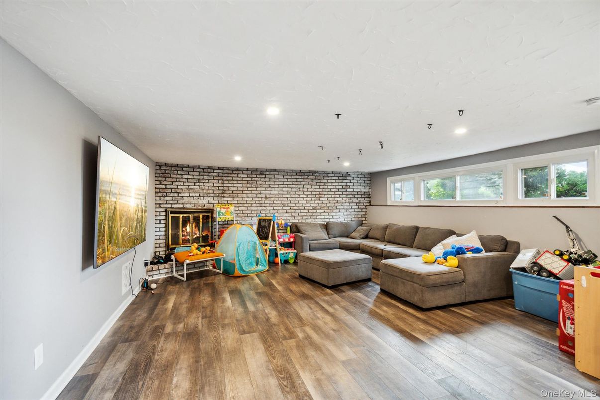 Fireplace, Interior, Living room, Recessed Lighting, Stone Walls, Wood Texture Flooring