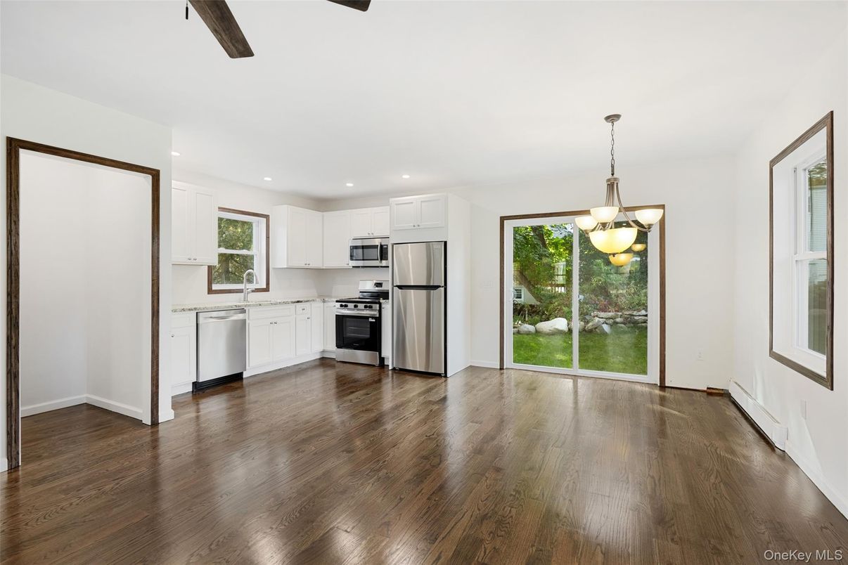 Empty room, Interior, Kitchen, Pendant Lights, Recessed Lighting, Stainless Steel Appliances, Wood Texture Flooring