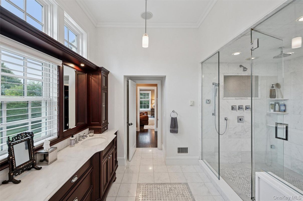Bathroom, Dual Sink Vanities, Glass Shower, Interior, Marble, Marble Walls, Pendant Lights, Recessed Lighting