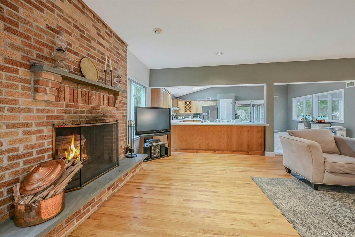 Fireplace, Interior, Living room, Recessed Lighting, Stone Walls, Wood Texture Flooring