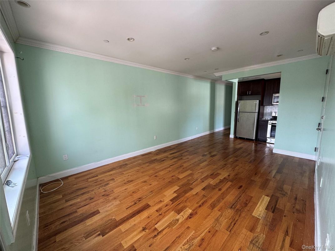 Empty room, Interior, Kitchen, Recessed Lighting, Stainless Steel Appliances, Wood Texture Flooring