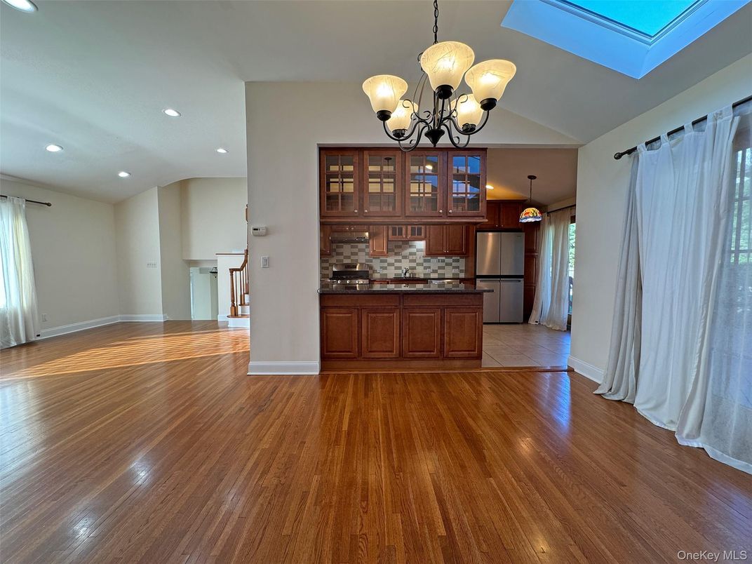 Chandelier, Empty room, Interior, Kitchen, Recessed Lighting, Stainless Steel Appliances, Wood Texture Flooring
