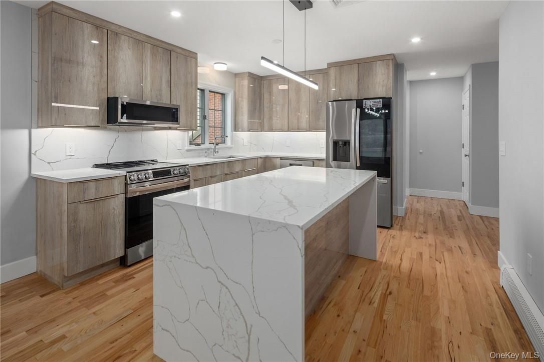 Interior, Kitchen, Marble Walls, Pendant Lights, Recessed Lighting, Stainless Steel Appliances, Wood Texture Flooring