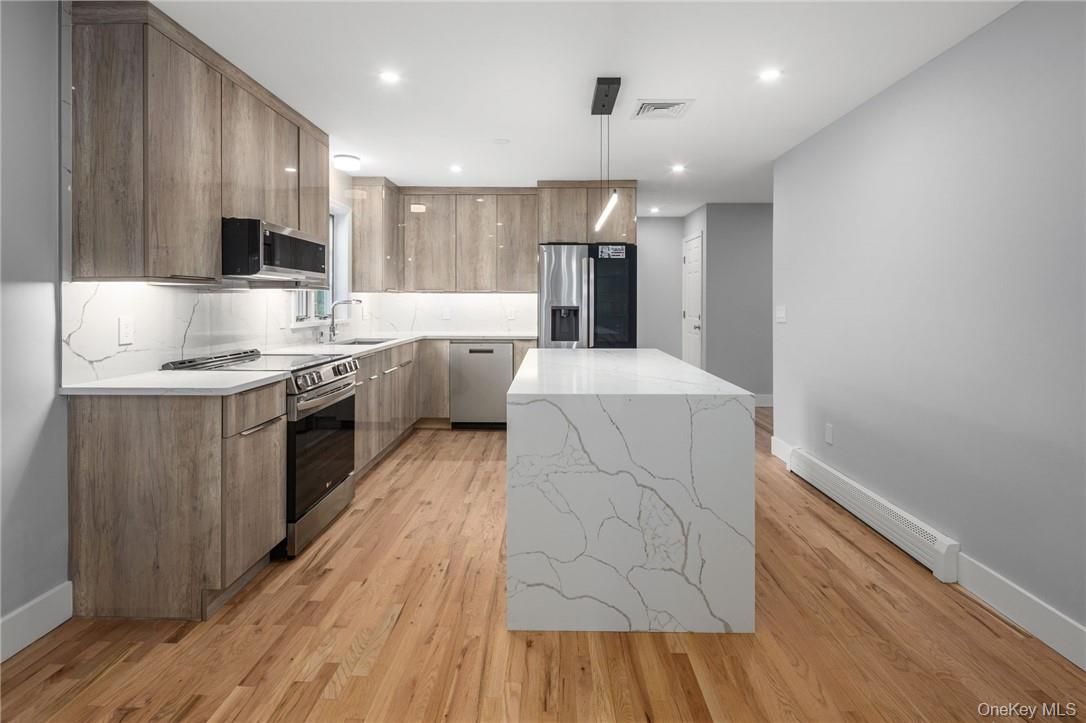 Interior, Kitchen, Marble Walls, Pendant Lights, Recessed Lighting, Stainless Steel Appliances, Wood Texture Flooring