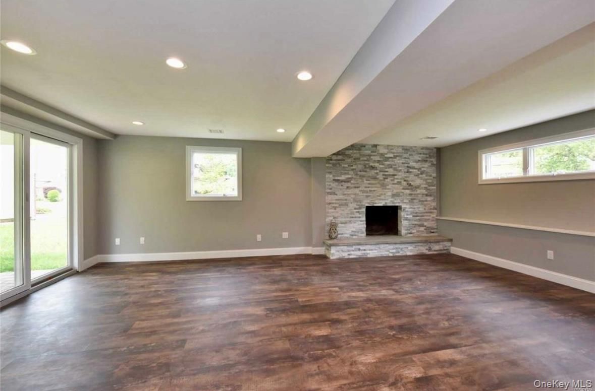Empty room, Fireplace, Interior, Recessed Lighting, Stone Walls, Wood Texture Flooring