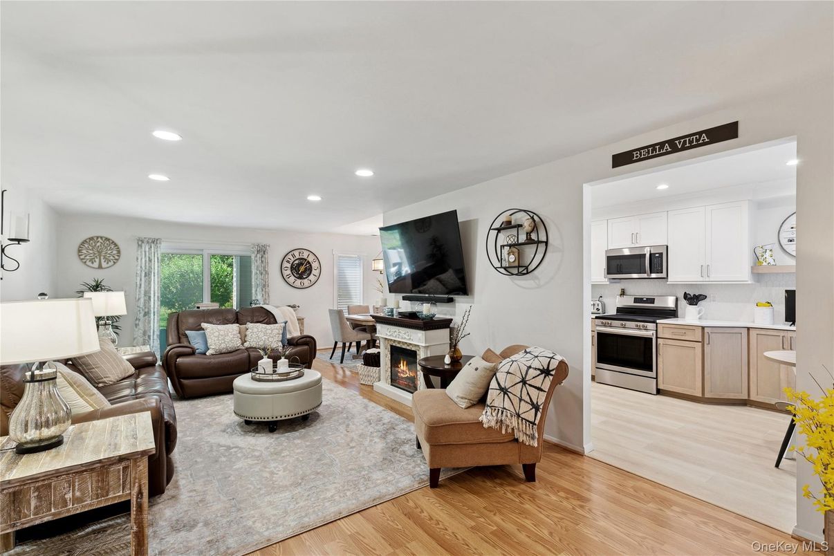 Fireplace, Interior, Kitchen, Living room, Recessed Lighting, Stainless Steel Appliances, Wood Texture Flooring