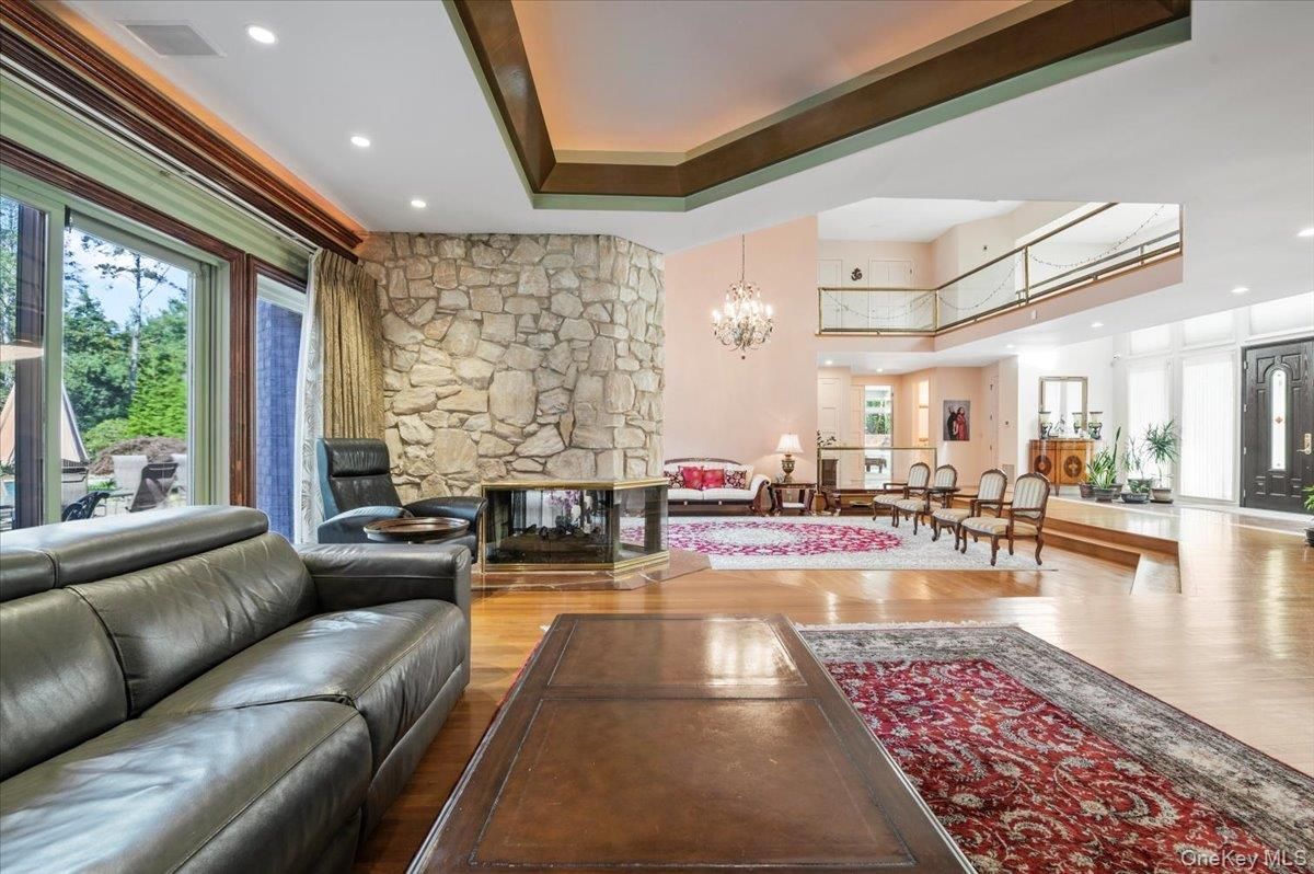 Chandelier, Dining room, Fireplace, Interior, Living room, Recessed Lighting, Stone Walls, Wood Texture Flooring