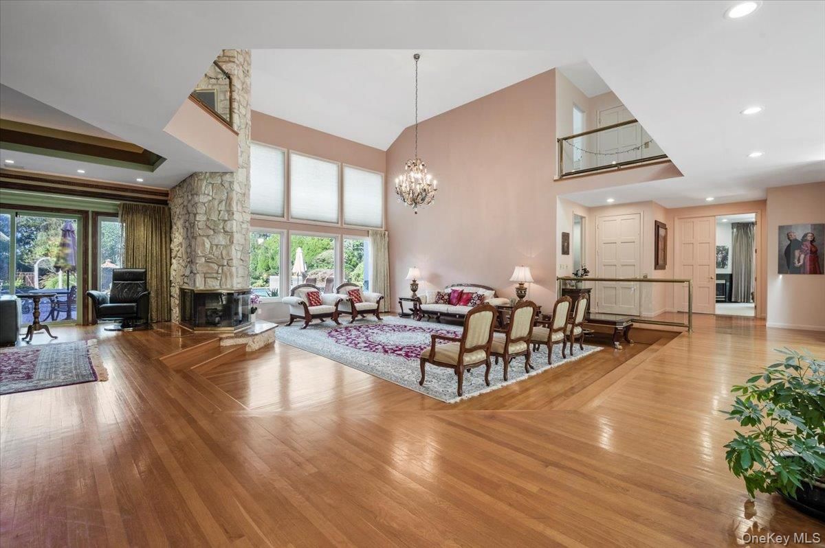 Chandelier, Fireplace, Interior, Living room, Recessed Lighting, Stone Walls, Wood Texture Flooring