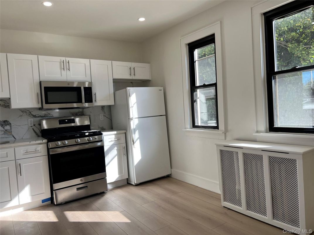 Interior, Kitchen, Marble Walls, Recessed Lighting, Stainless Steel Appliances, Wood Texture Flooring