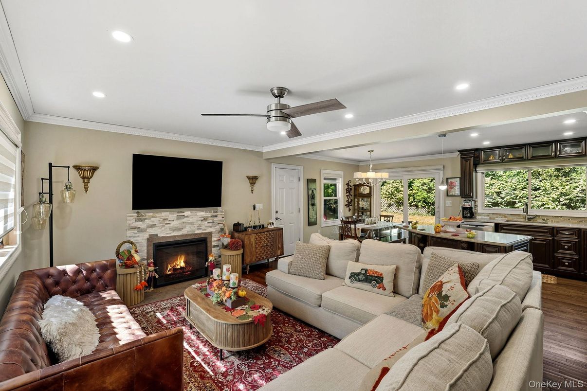 Chandelier, Dining room, Fireplace, Interior, Living room, Pendant Lights, Recessed Lighting, Wood Texture Flooring