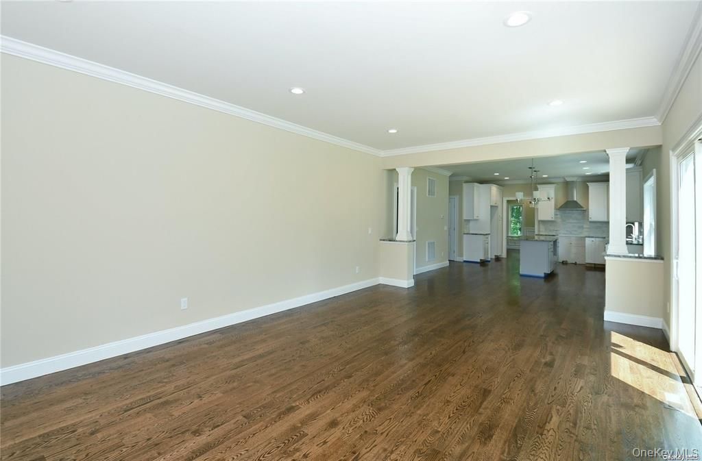 Empty room, Interior, Kitchen, Pendant Lights, Recessed Lighting, Stainless Steel Appliances, Wood Texture Flooring