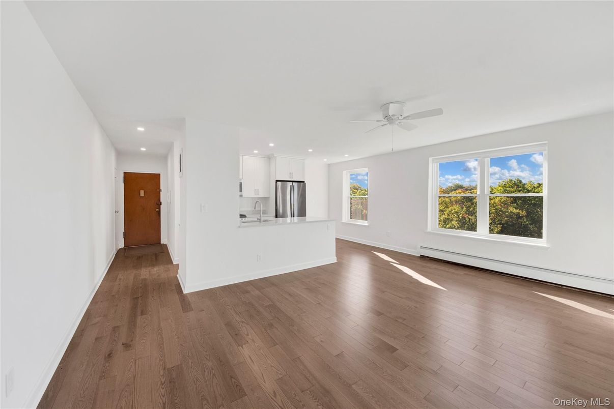 Empty room, Interior, Kitchen, Recessed Lighting, Stainless Steel Appliances, Wood Texture Flooring