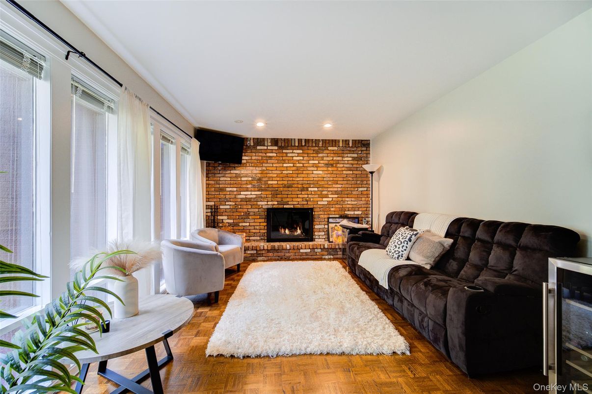 Fireplace, Interior, Living room, Recessed Lighting, Stone Walls, Wood Texture Flooring