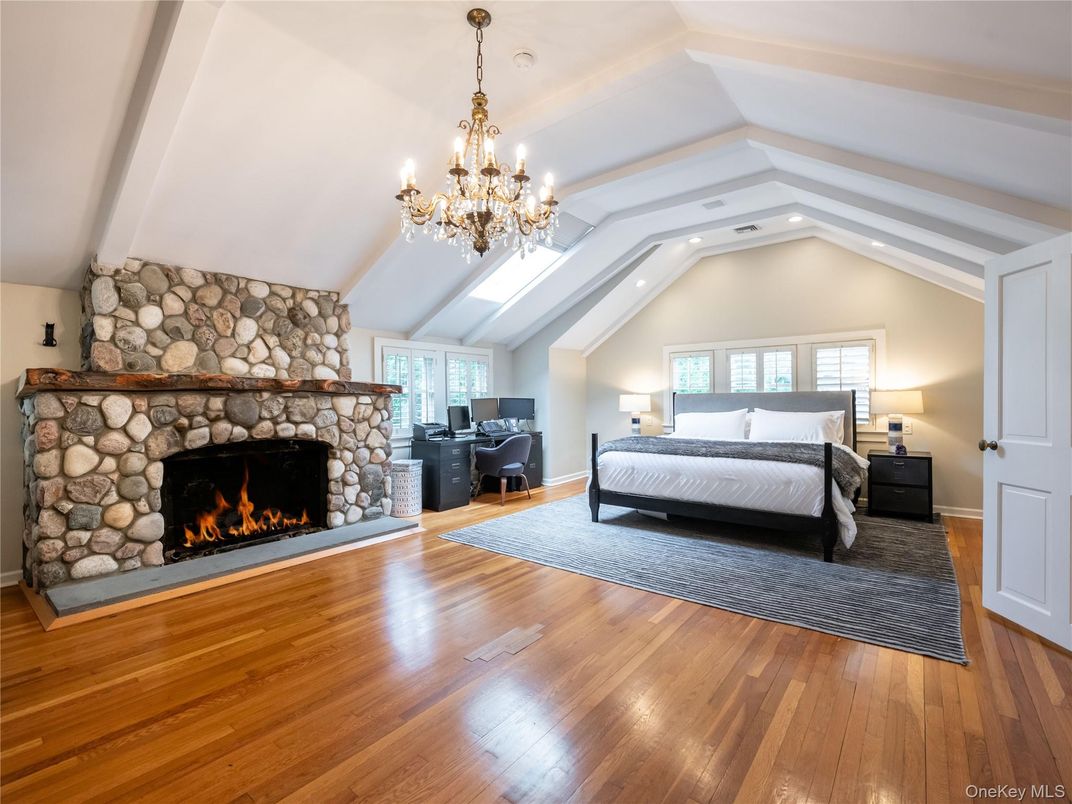 Bedroom, Chandelier, Fireplace, Interior, Recessed Lighting, Stone Walls, Wood Texture Flooring