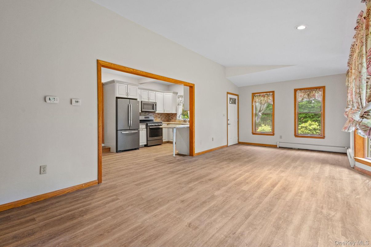 Empty room, Interior, Kitchen, Recessed Lighting, Stainless Steel Appliances, Wood Texture Flooring