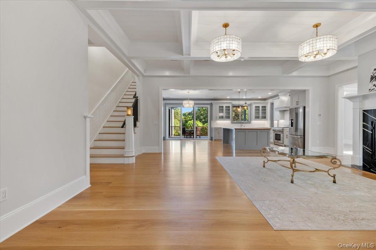 Chandelier, Fireplace, Interior, Kitchen, Pendant Lights, Stainless Steel Appliances, Wood Texture Flooring