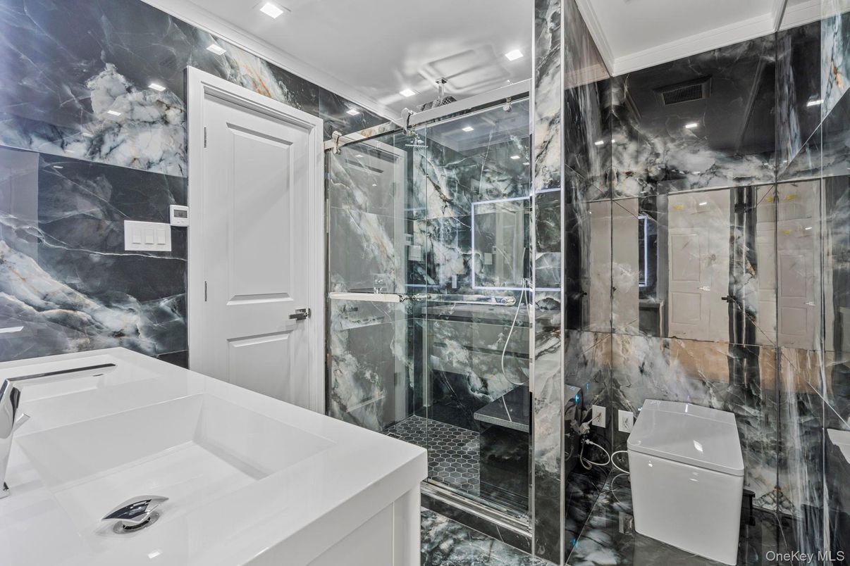 Bathroom, Dual Sink Vanities, Glass Shower, Interior, Marble Walls, Recessed Lighting