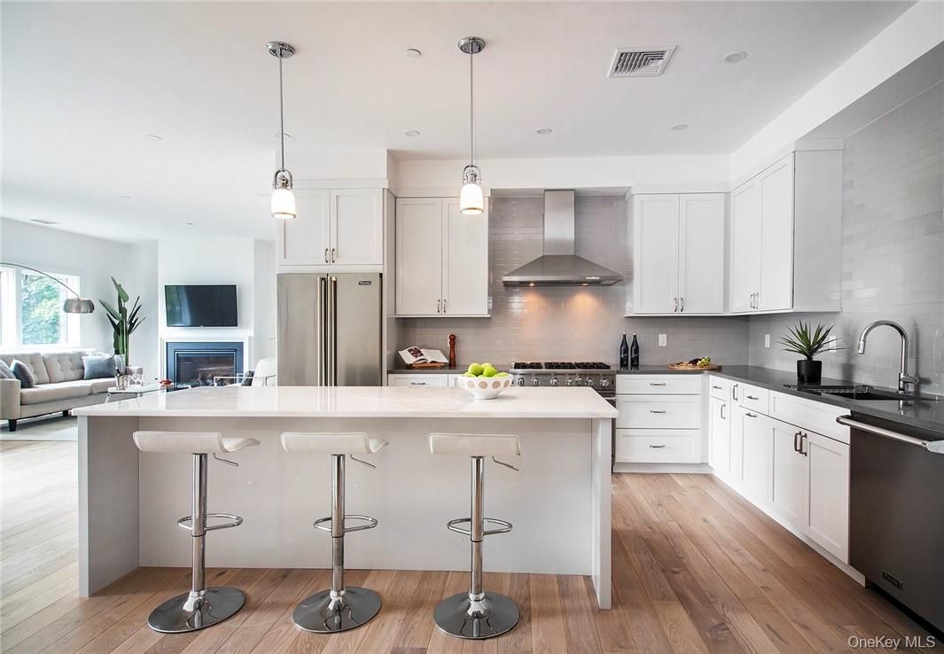 Fireplace, Interior, Kitchen, Living room, Pendant Lights, Recessed Lighting, Stainless Steel Appliances, Wood Texture Flooring