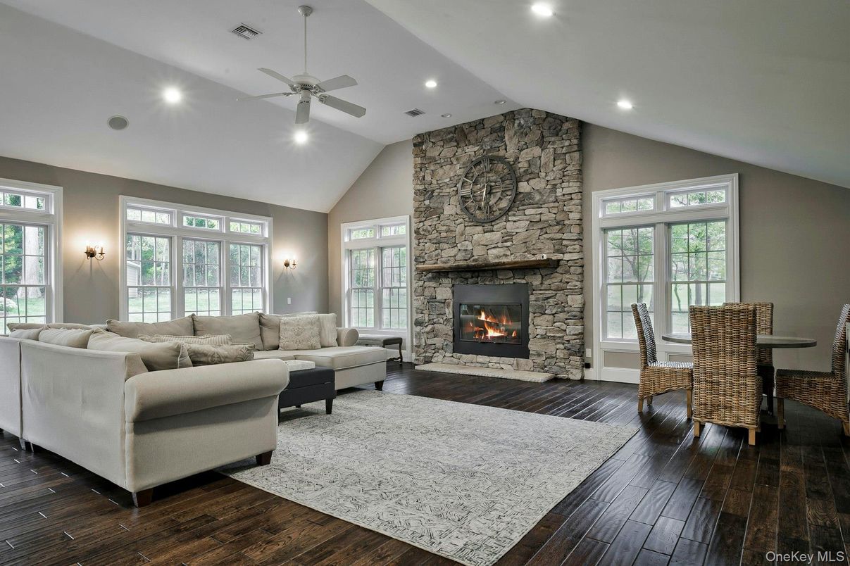 Dining room, Fireplace, Interior, Living room, Recessed Lighting, Stone Walls, Wood Texture Flooring