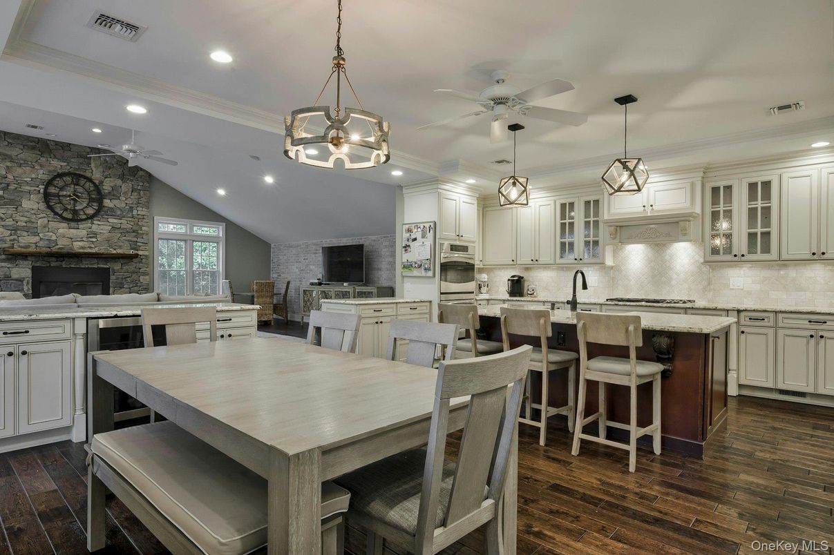 Fireplace, Interior, Kitchen, Pendant Lights, Recessed Lighting, Stainless Steel Appliances, Stone Walls, Wood Texture Flooring