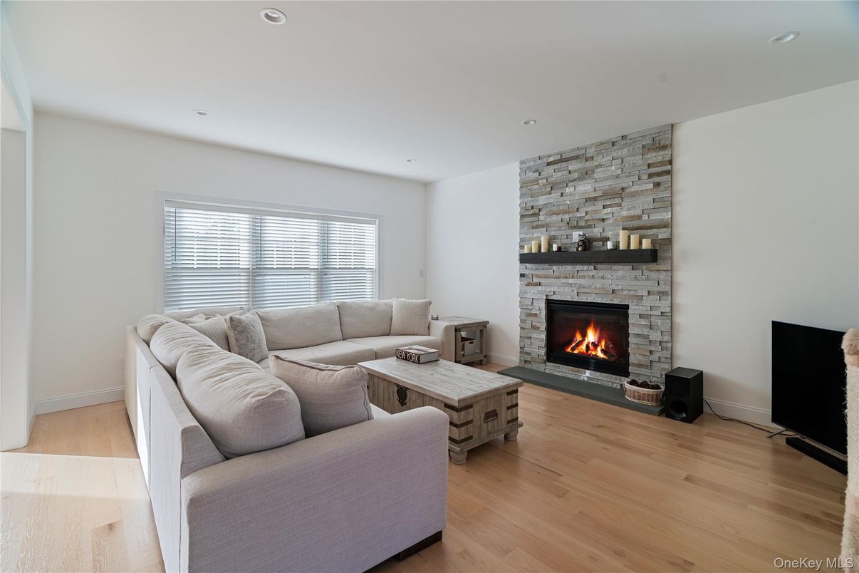 Fireplace, Interior, Living room, Recessed Lighting, Stone Walls, Wood Texture Flooring