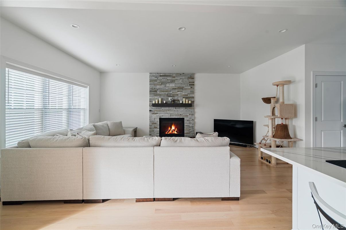 Fireplace, Interior, Living room, Recessed Lighting, Stone Walls, Wood Texture Flooring