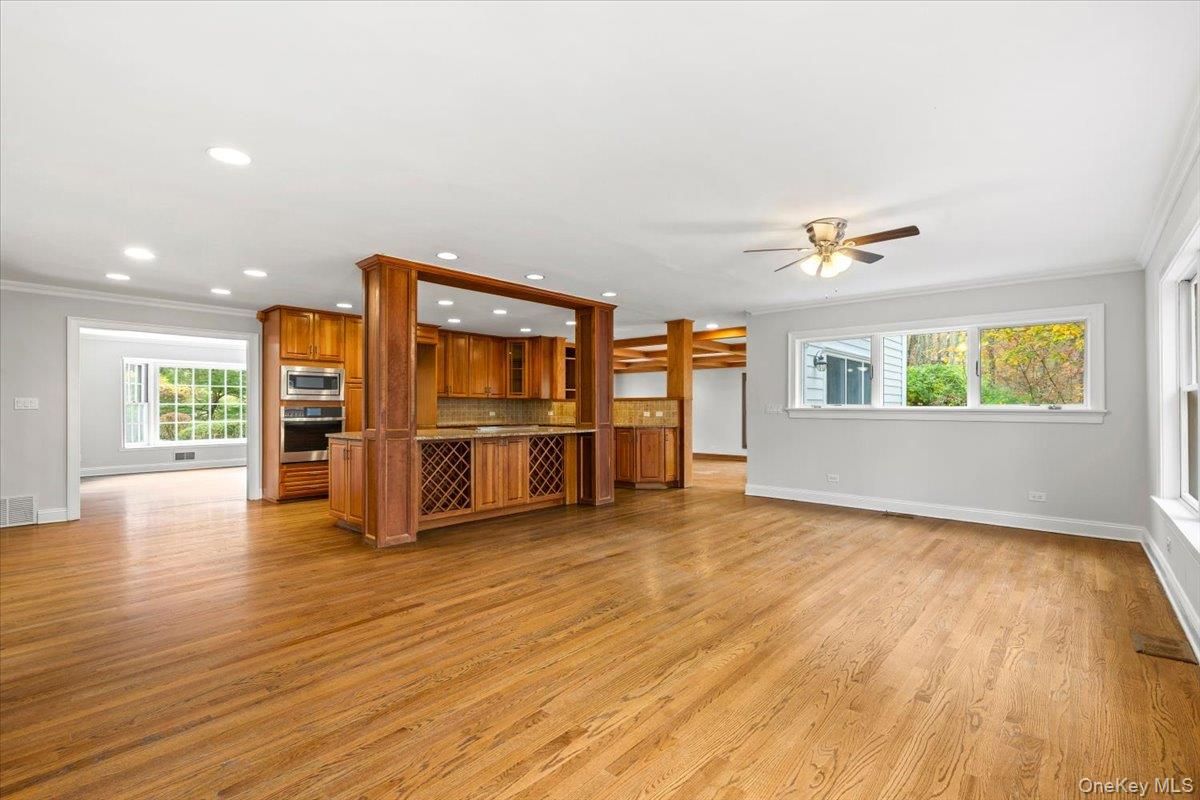 Empty room, Interior, Kitchen, Recessed Lighting, Stainless Steel Appliances, Wood Texture Flooring